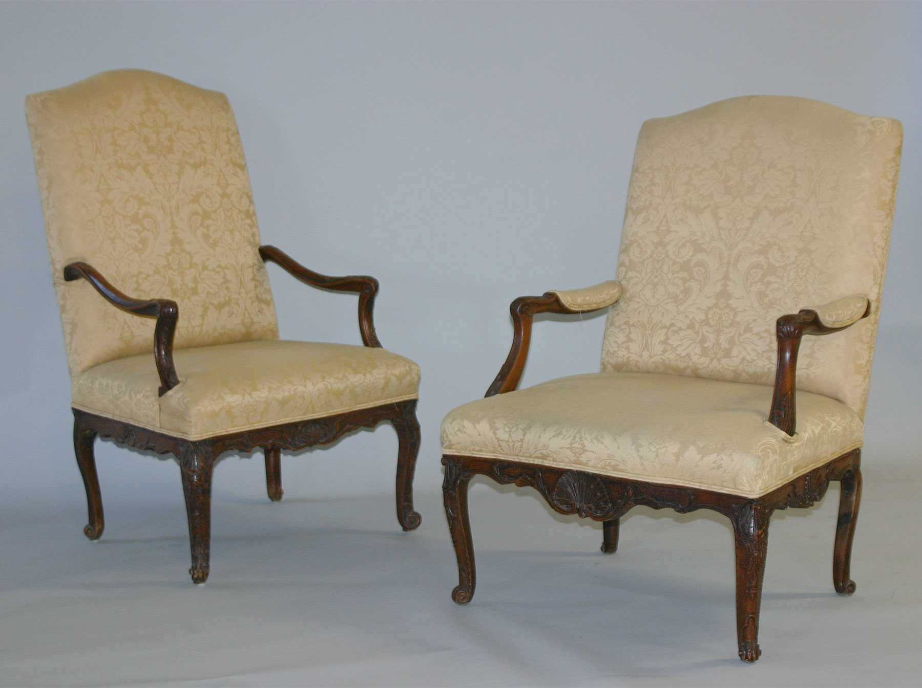 Companion pair of French Regence style Fauteuils
